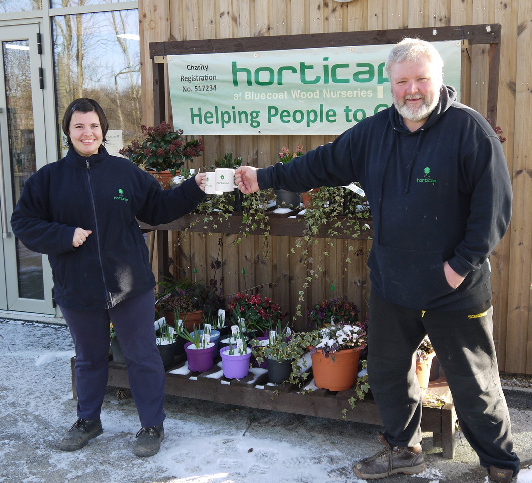 Phil Airey, Operations Manager at Horticap, and student Rebecca raising their mugs to Belmont Grosvenor School to say thanks for the cash boost