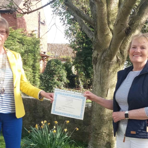 Dorothy Taylor receives long service certificate from President Sandra Frier