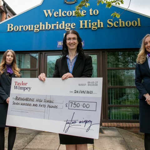 Headteacher-Kathryn-Stephenson-centre-with-Taylor-Wimpey-sales-executives-Victoria-Franks-left-with-Abby-Timmins-right