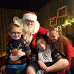 Jack Mangan with his brother Josh and sister Georgia, meeting Santa Claus