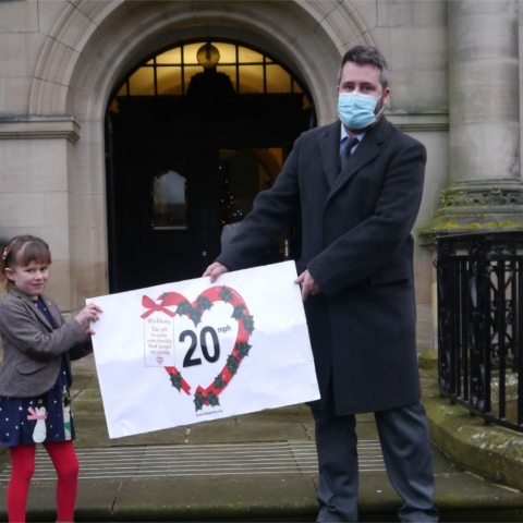 Last month, Poppy (aged 6) presented a Giant 20mph Christmas Card to Daniel Harry of Democratic Services at NYCC, on behalf of 56 Town and Parish Councils supporting the 20s Plenty default 20mph campaign.