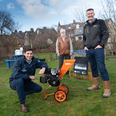Mike Craddock from Brierley Homes, John Hart, Chair of the Trustees of the Woodfield Millennium Green, and Eddie Ashworth from The HACS group, with the wood chipper