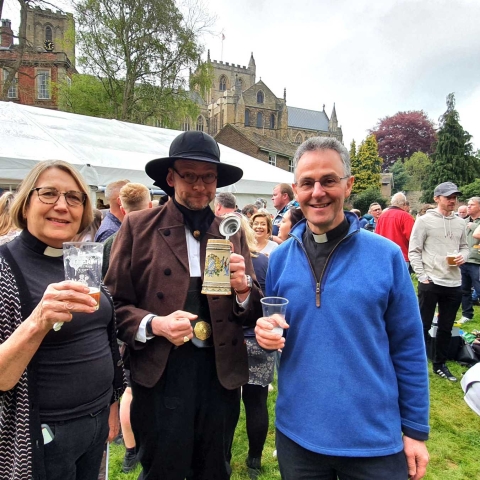 Canon Ailsa Newby, Dr Ronny Krippner (Director of Music) in National Dress of Austria, The Very Rev’d John Dobson, Dean of Ripon at Beer Festival on May Da