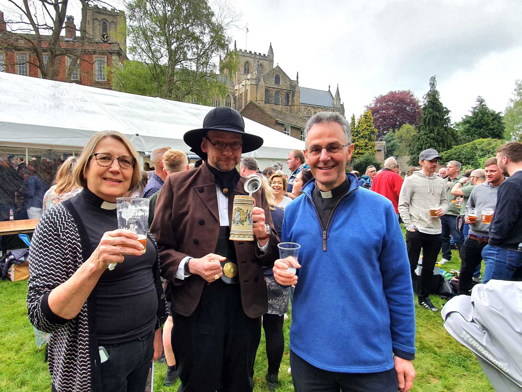 Canon Ailsa Newby, Dr Ronny Krippner (Director of Music) in National Dress of Austria, The Very Rev’d John Dobson, Dean of Ripon at Beer Festival on May Da
