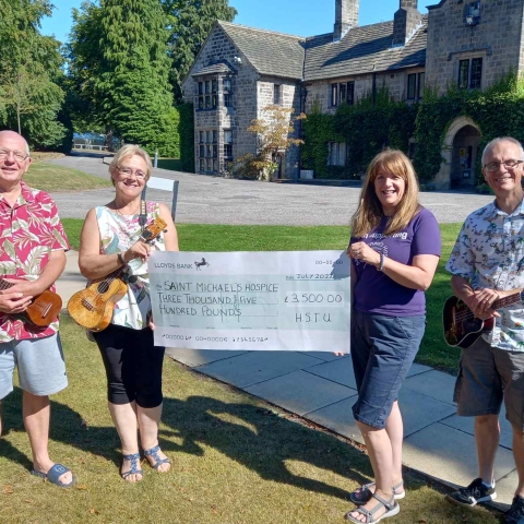 Steve Bullock, band leader, Karen Bellerby, HSTU Chair, presenting the cheque of £3500 to Sandra Gilbert representing Saint Michael's and Neal Carr, treasurer, at Crimple House, Saint Michael's head office