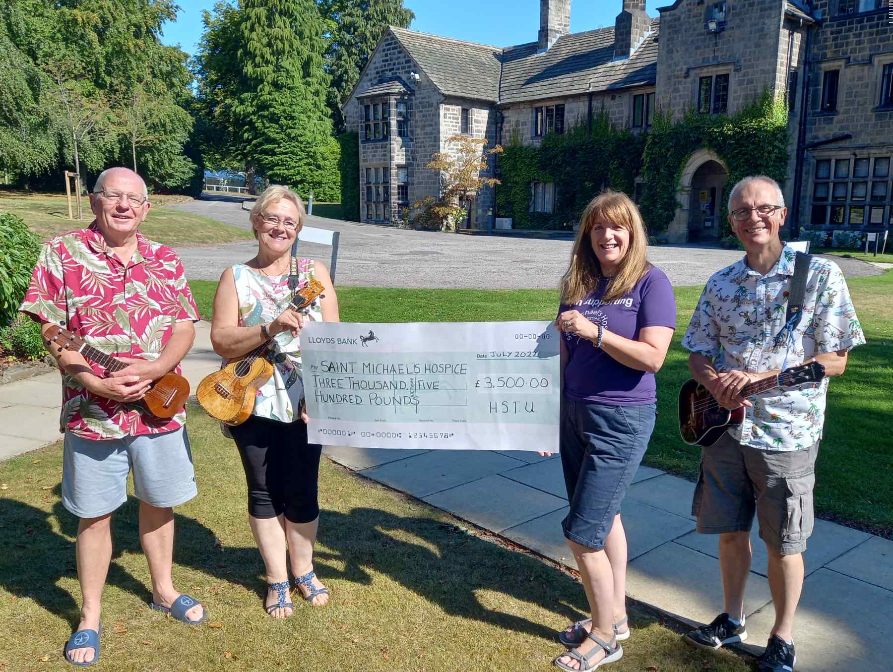 Steve Bullock, band leader, Karen Bellerby, HSTU Chair, presenting the cheque of £3500 to Sandra Gilbert representing Saint Michael's and Neal Carr, treasurer, at Crimple House, Saint Michael's head office