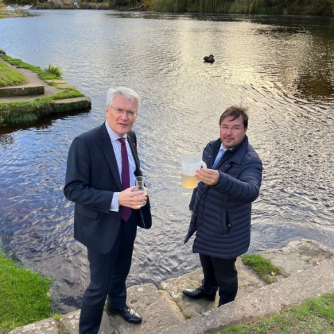 Andrew Jones MP and Frank Maguire looking at a sample of the river water