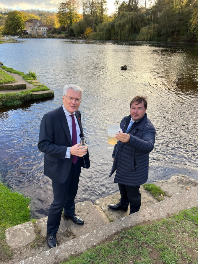 Andrew Jones MP and Frank Maguire looking at a sample of the river water