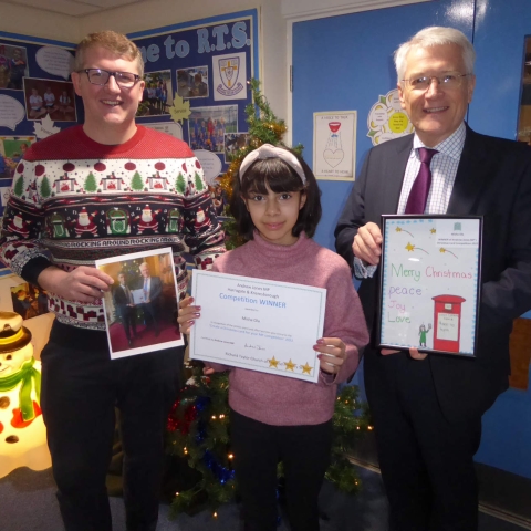 Andrew and Richard Taylor Headteacher Andrew Symonds present Misha with her framed winning card and certificate