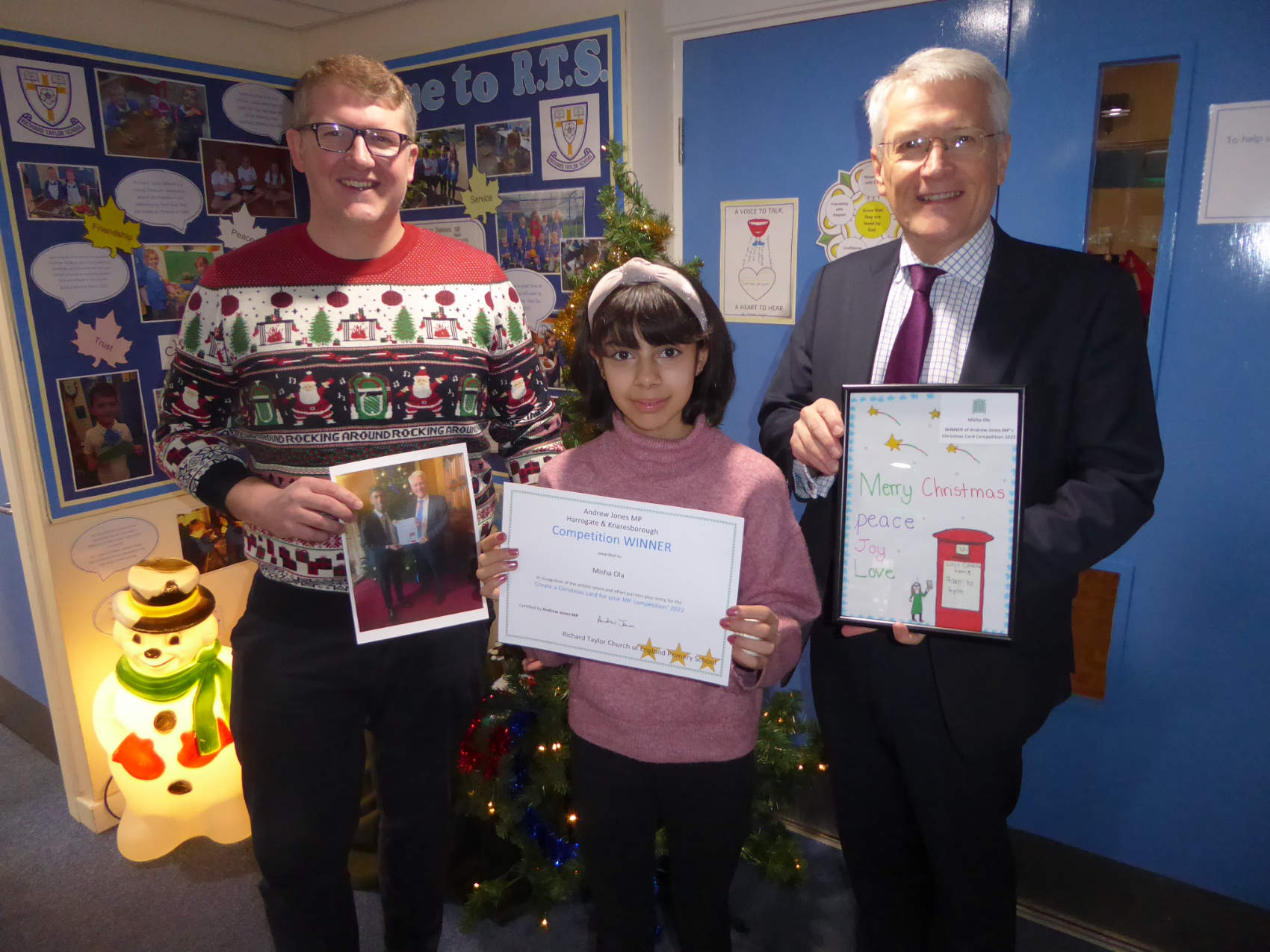 Andrew and Richard Taylor Headteacher Andrew Symonds present Misha with her framed winning card and certificate