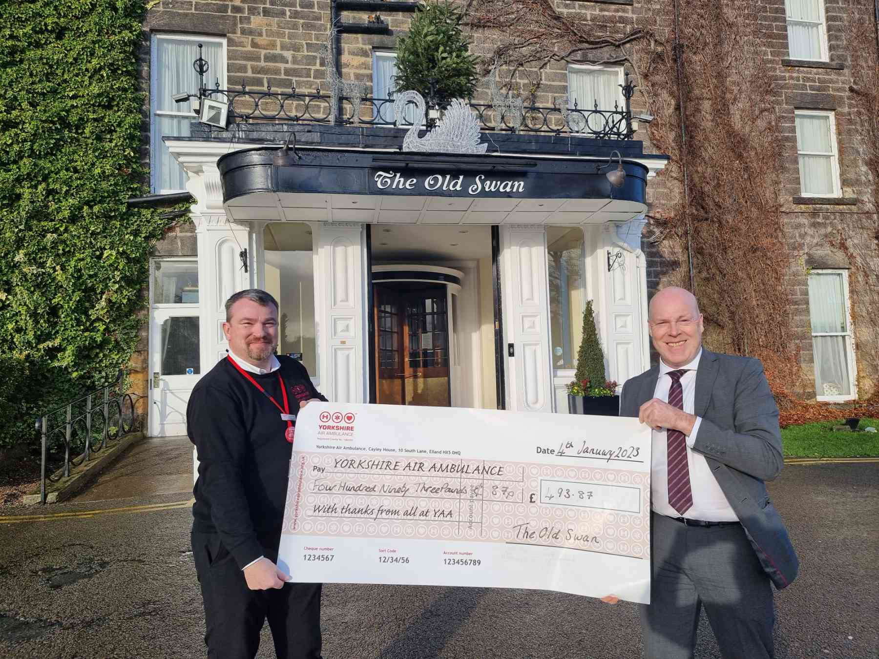 David Ritson General Manager at The Old Swan, presents a cheque for £493.87 to Jonathan Heeley, Regional Fundraiser at Yorkshire Air Ambulance