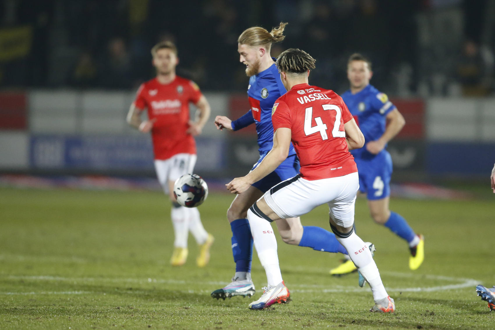Harrogate Town forward Luke Armstrong (29) goes past Salford City defender Theo Vassell (42) during the EFL Sky Bet League 2 match between Salford City and Harrogate Town at the Peninsula Stadium, Salford, United Kingdom on 14 February 2023.