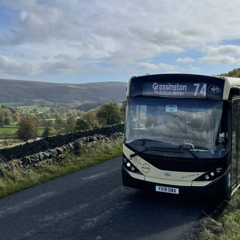 Saturday DalesBus 74 Service parked near Burnsall with a wonderful view across Wharfedale to Simon’s Seat