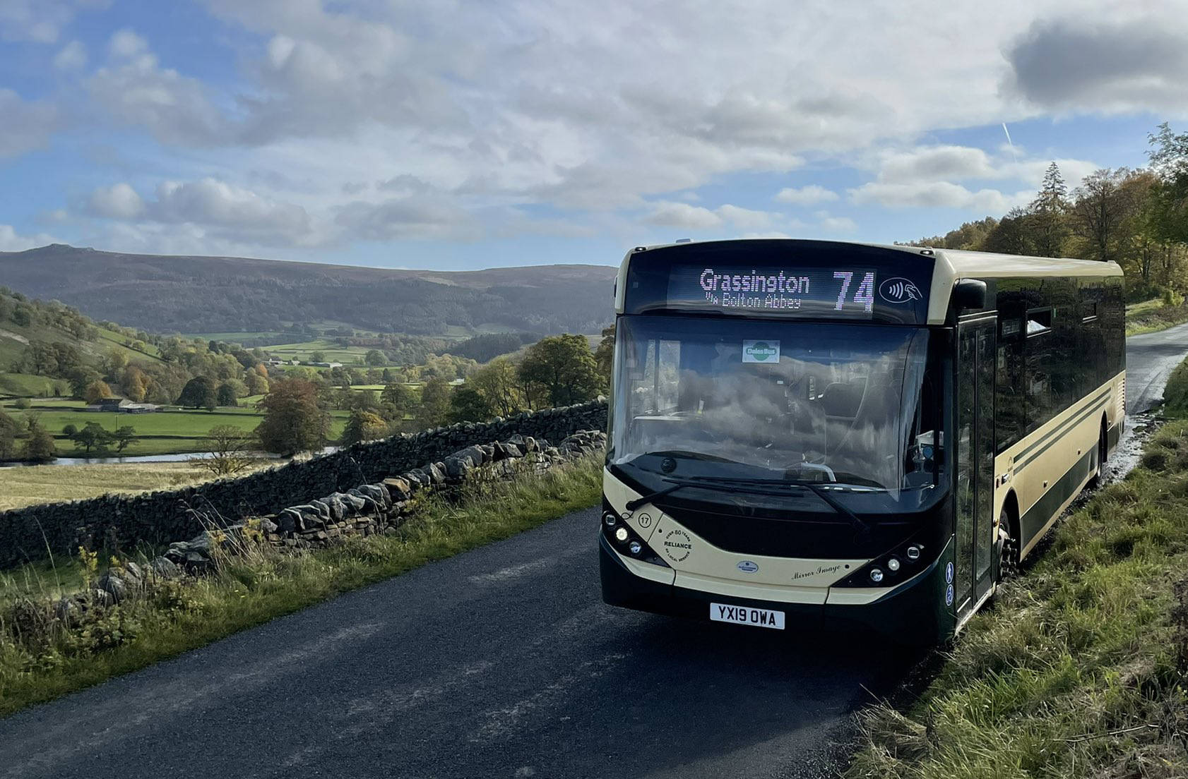 Saturday DalesBus 74 Service parked near Burnsall with a wonderful view across Wharfedale to Simon’s Seat