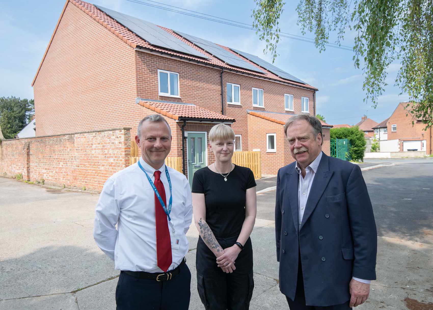 North Yorkshire Council’s executive member for housing, Cllr Simon Myers (right), Clare Edwards and North Yorkshire Council’s head of housing, Andrew Rowe, outside the new homes in Ripon