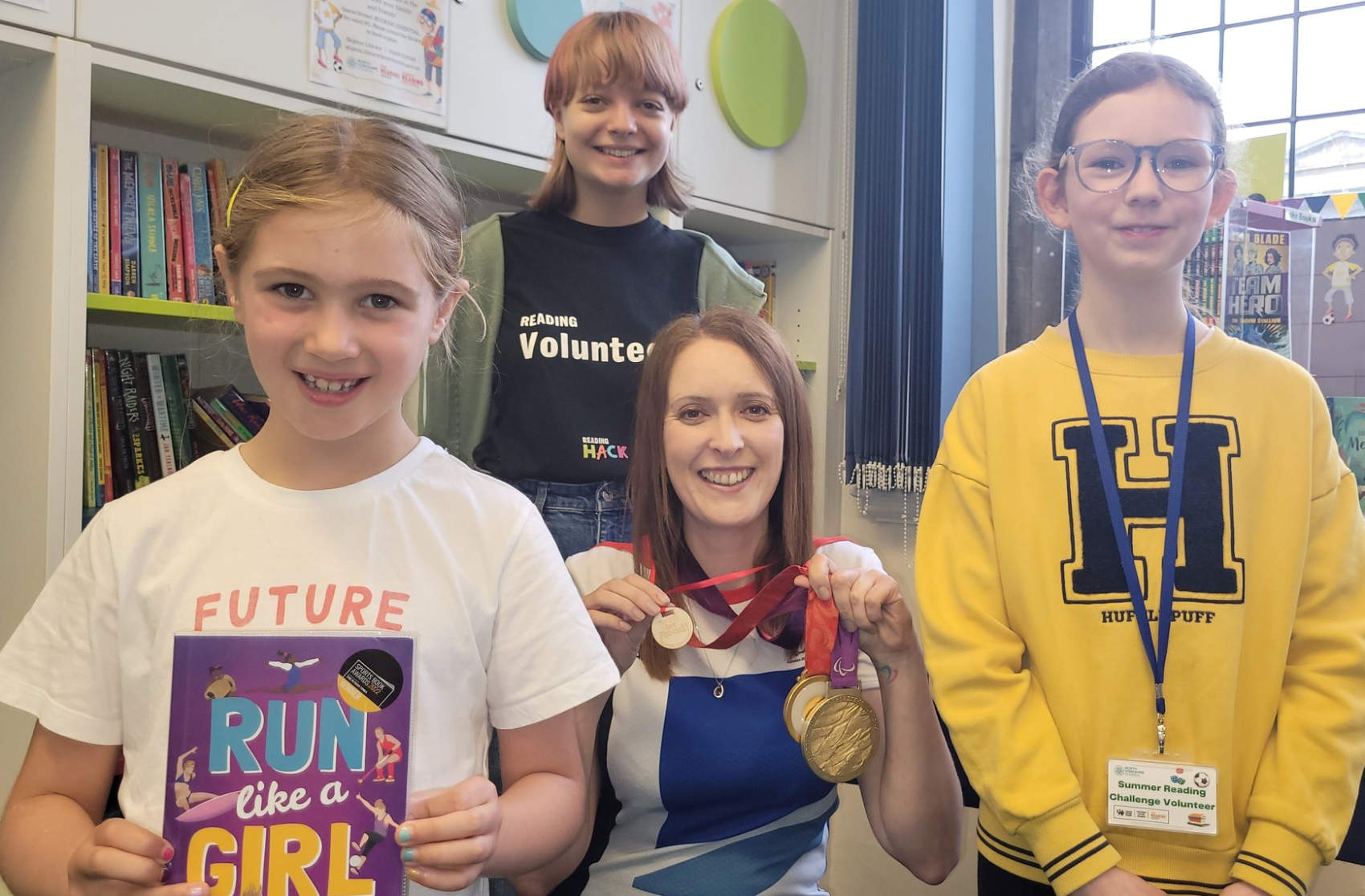 North Yorkshire-based Paralympian and author Danielle Brown with her gold medals and an honorary Ready, Set, Read medal. Danielle visited Skipton library to talk about how she overcame disability, nerves and lack of confidence to become an Olympic champion in Beijing and London. With Danielle are two of Skipton library’s young volunteer Reading Hacks, Beth Kent, 12, and Emily Scott, 16, while Summer Reading Challenge participant Lucy Browne, seven, holds Danielle's book, Run Like a Girl