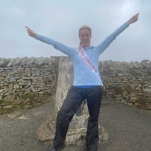 Miss Yorkshire winner Chloe McEwen celebrating one of the Three Peaks in her Miss Yorkshire sash and crown