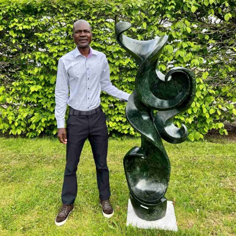 Zimbabwean sculptor Dudzai Mushawepwere with one of the sculptures at the Matombo exhibition being held at Newby Hall, near Ripon