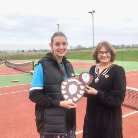 President Christine Anderson presenting the shield to Sofia Perez