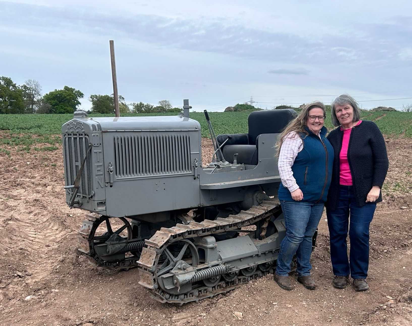 Emily Drury Alcock and Janet Carr with the Cat 10 High Clear that will be debuting at Tractor Fest