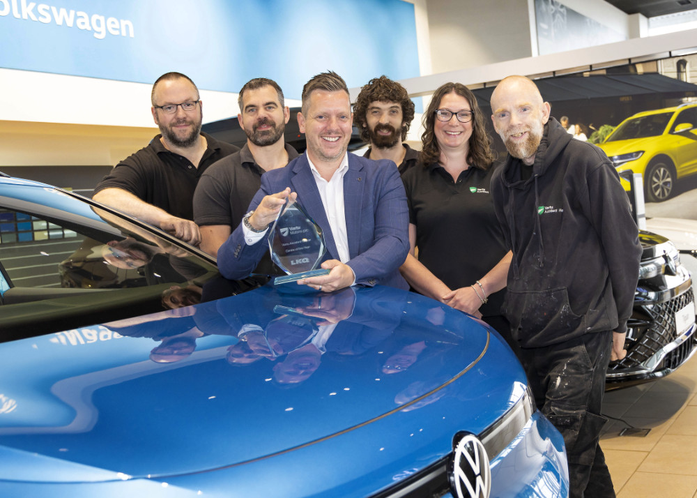Phil Simpson, Manager of the Accident Repair Centre (holding trophy) with some of the team