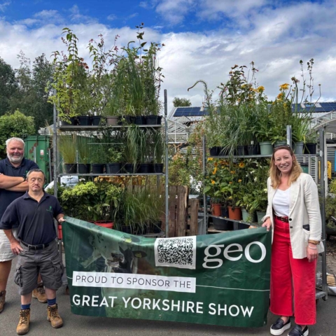Phil Airey, Operations Manager at Horticap; Stephen, a student at Horticap; and Kate Bush, Head of Agriculture at Geo Underwriting, at the Horticap shop, with the plants the company donated