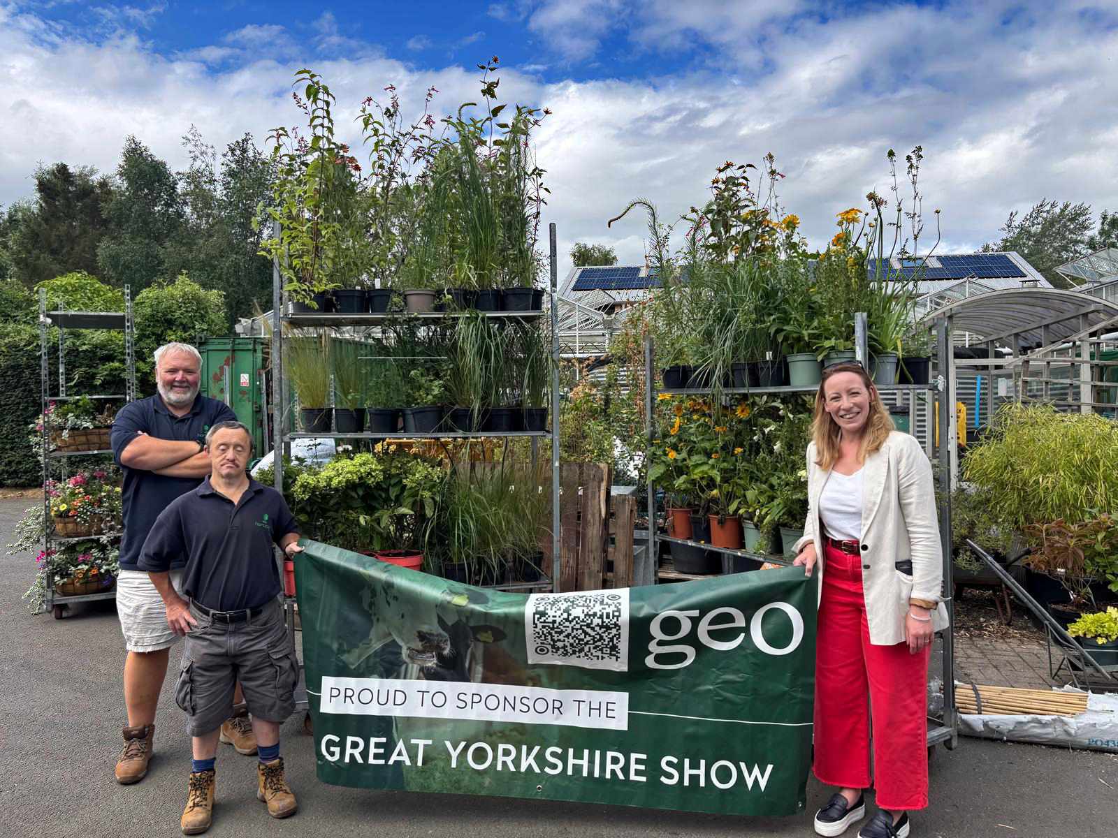 Phil Airey, Operations Manager at Horticap; Stephen, a student at Horticap; and Kate Bush, Head of Agriculture at Geo Underwriting, at the Horticap shop, with the plants the company donated
