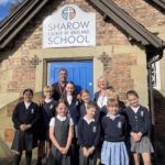 Chris Kamara with pupils at Sharow Church of England Primary School alongside headteacher Jacqui Palmer