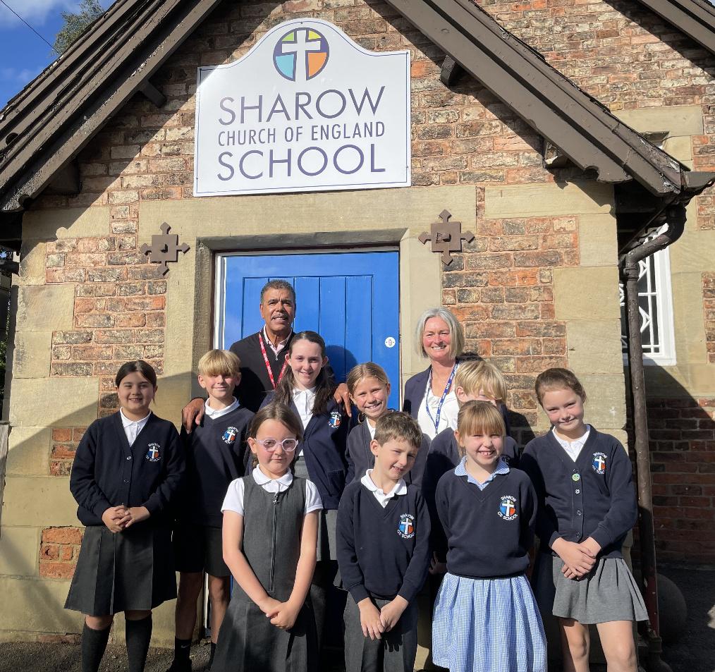 Chris Kamara with pupils at Sharow Church of England Primary School alongside headteacher Jacqui Palmer