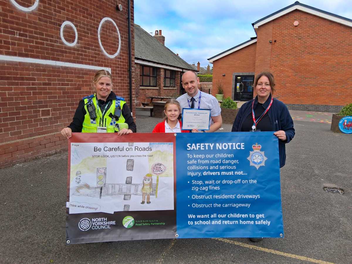 From left, Police Community Support Officer at North Yorkshire Police, Natalie Blacker, Filey Junior School pupil Freya Hammerton, who is the winner of the banner competition, headteacher Michael Taylor, and community safety officer at North Yorkshire Council, Karen Nattress