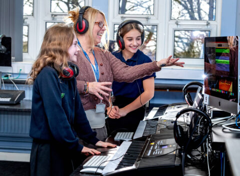 Wensleydale School’s headteacher Julia Polley is pictured with pupils Nina Wilmington, left, and Lilly Dalton using keyboards and state-of-the-art computer software to compose music.