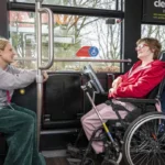 Henshaws student Georgia (right) and Katherine, her support staff member (left), board a Mercedes-Benz eCitaro with the help of driver Lyndsey Evans (behind), operated by the Harrogate Bus Company.