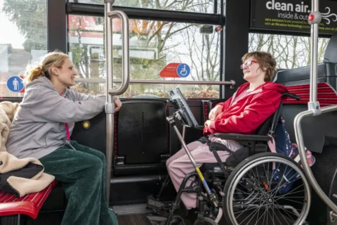 Henshaws student Georgia (right) and Katherine, her support staff member (left), board a Mercedes-Benz eCitaro with the help of driver Lyndsey Evans (behind), operated by the Harrogate Bus Company.