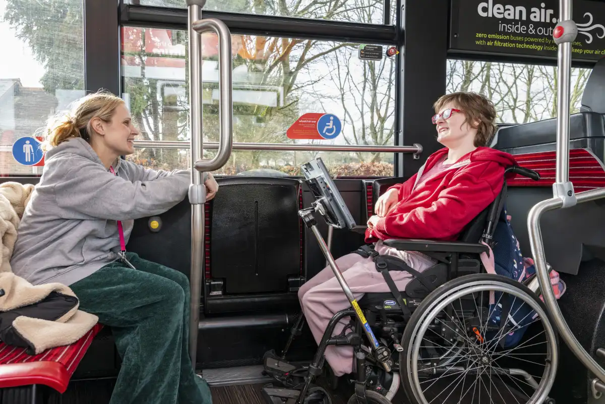 Henshaws student Georgia (right) and Katherine, her support staff member (left), board a Mercedes-Benz eCitaro with the help of driver Lyndsey Evans (behind), operated by the Harrogate Bus Company.