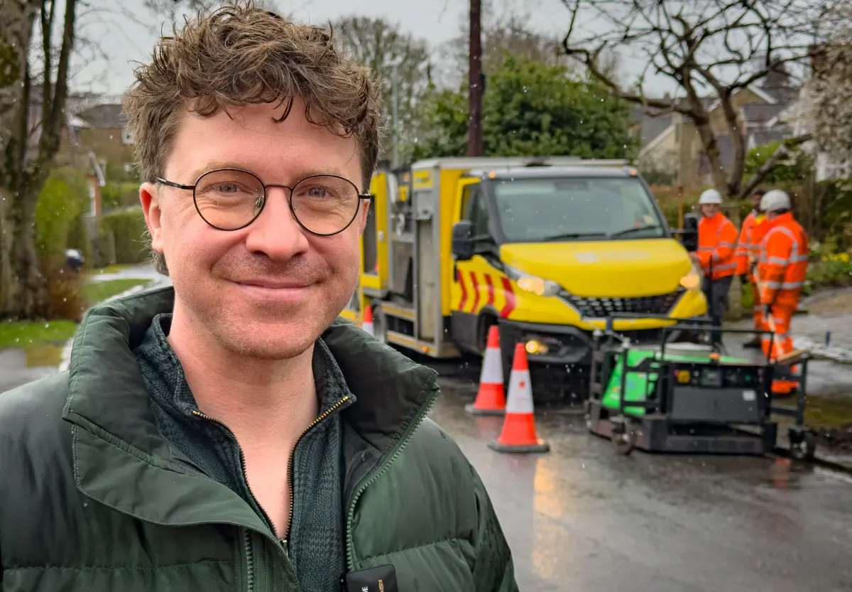(credit - Leeds City Council): Leeds City Council’s deputy leader and executive member for economy, transport and sustainable development, Councillor Jonathan Pryor, with the Thermal Road Repairs machine filling potholes in a Leeds residential area.