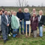 Some of City of York Council's foster carers, together with representatives from the council's Children's Services team and Forestry England next to the new plaque.