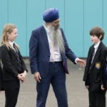 Headteacher, Mr Sukhraj Gill, with pupils at Harrogate High School