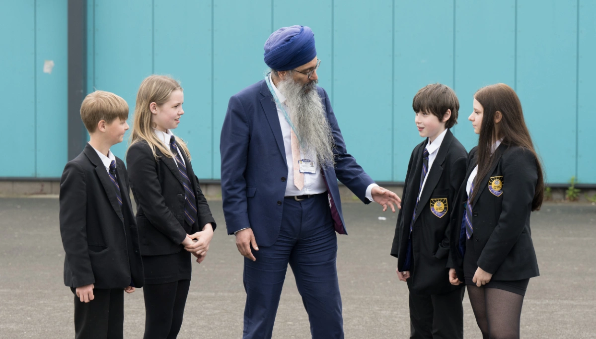 Headteacher, Mr Sukhraj Gill, with pupils at Harrogate High School