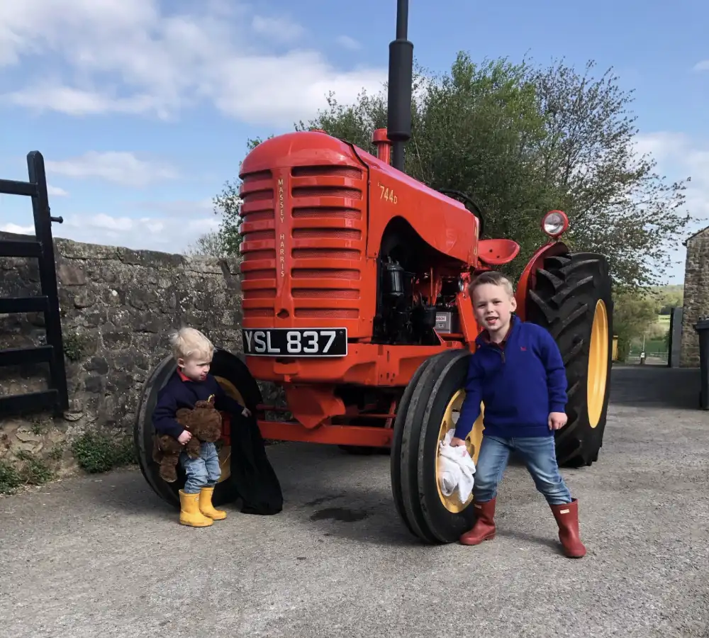 Mark Dean's sons 2-year-old George and James (4) put the finishing touches to his Massey Harris Tractor