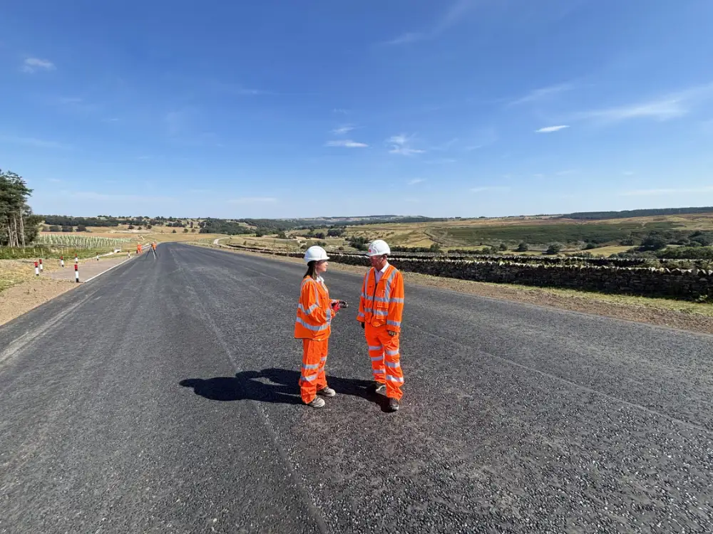 North Yorkshire Council’s executive member for highways and transportation, Cllr Malcolm Taylor, right, is pictured with Lauren Luck, a regional engineer at the contractors involved in the Kex Gill realignment project, Sisk Infrastructure, on the new stretch of the A59.