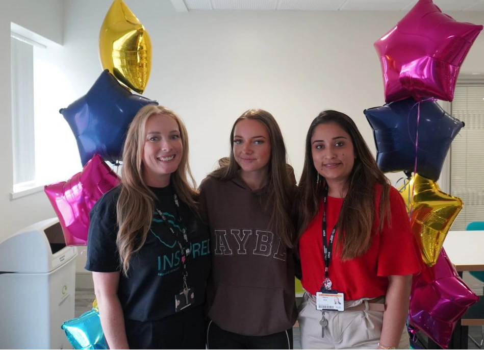 Sophie Chaplin celebrates her GCSE results by posing with tutors Laura Heward (left) and Naduni Silva (right) accompanied by star-shaped balloons